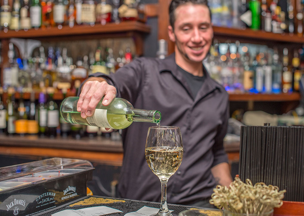 Taddeos-Bartender-Pouring-white-wine